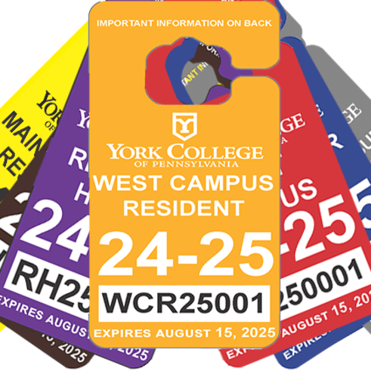 A stack of parking permits in a variety of colors.