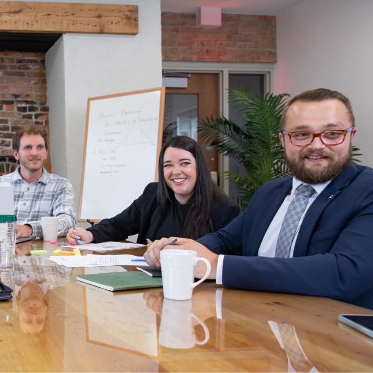 York College students sit around a table discussing a business report.