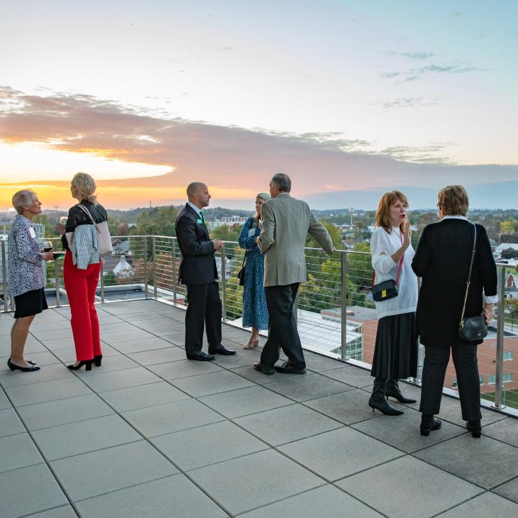Sunset over York seen from the balcony of Yorkview with people gathered at an event