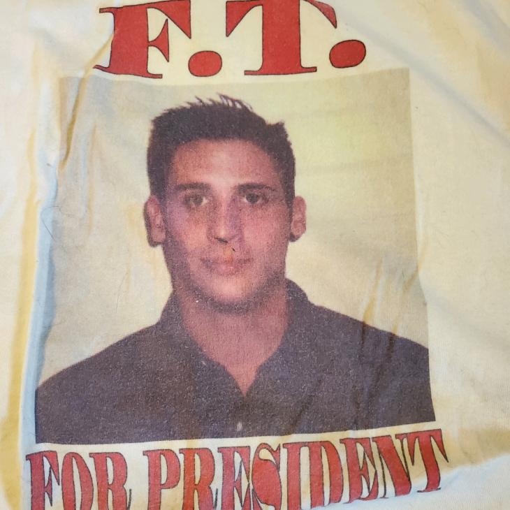 A white shirt features a printed photo of Frank Thomas “F.T.” Aquilino with red text reading “F.T. for President.”